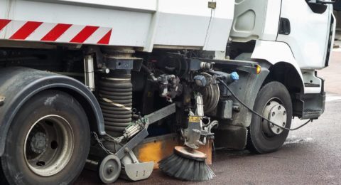 Close up of a truck cleaning a street