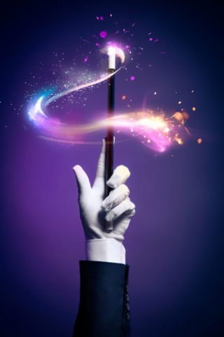 High contrast image of magician hand with magic wand